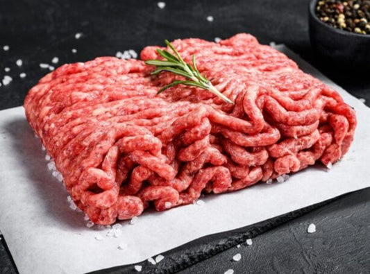 Pork mince on black cutting board.